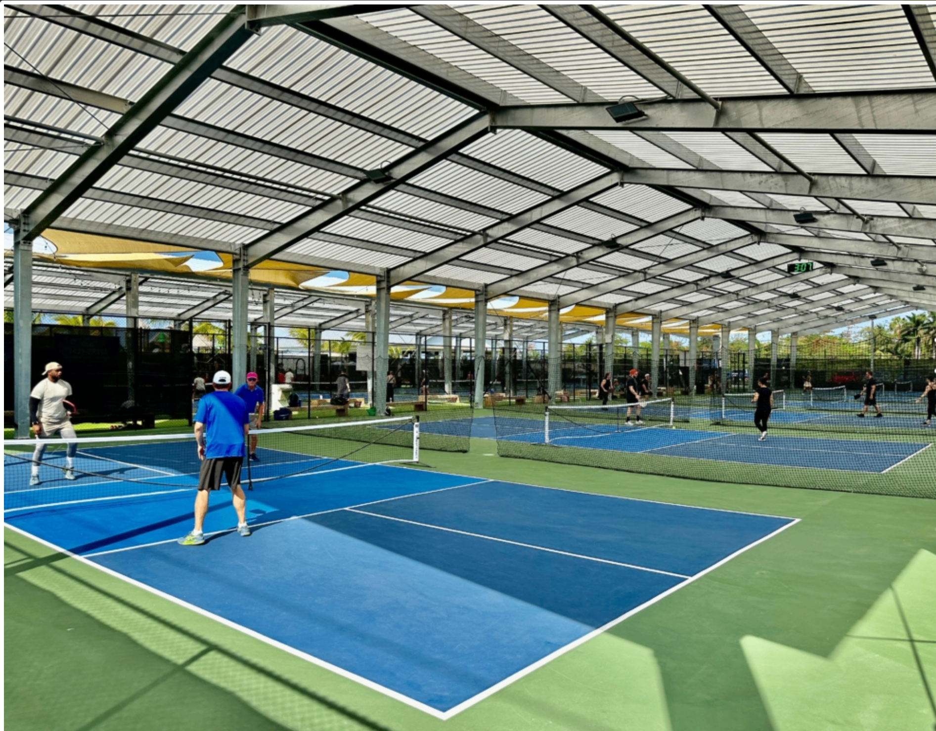 Active adults playing pickleball outdoors in the Cayman Islands